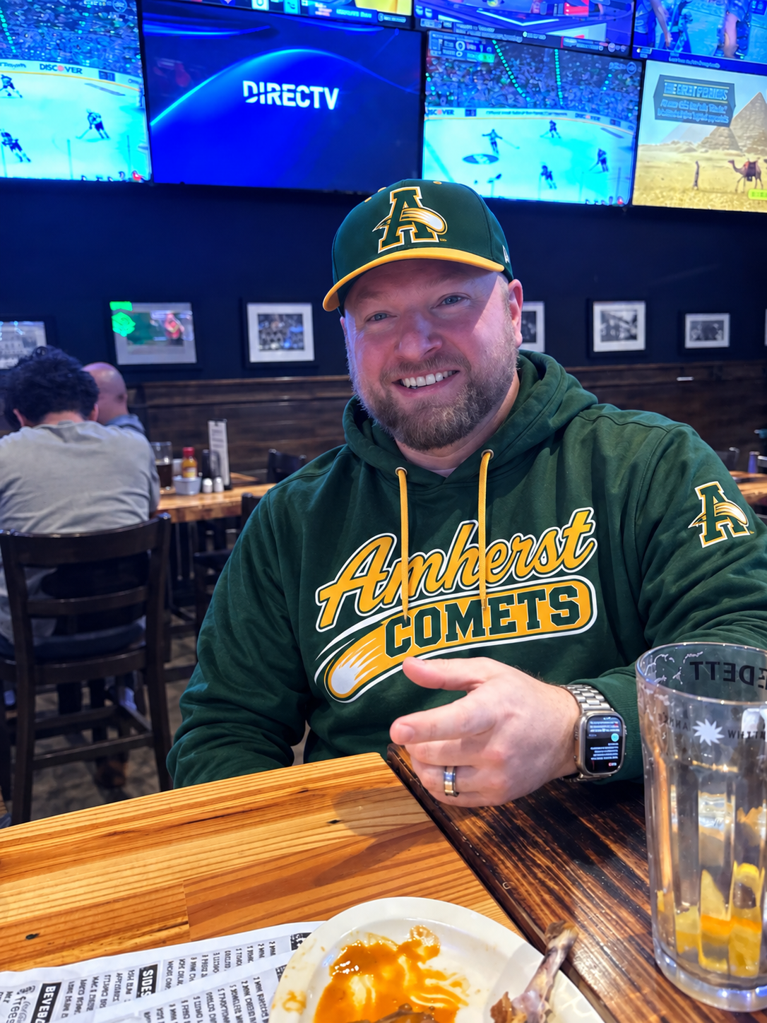 Coach Scott wearing his Amherst Comets hat and hoodie